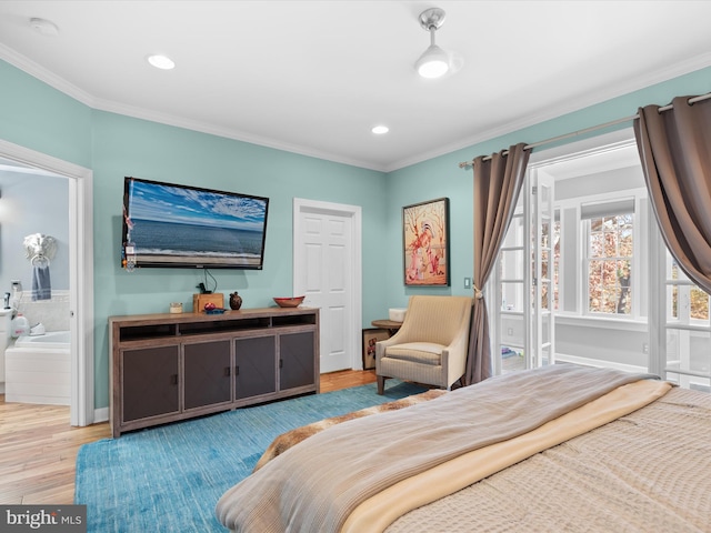 bedroom with light hardwood / wood-style floors, ornamental molding, and ensuite bath