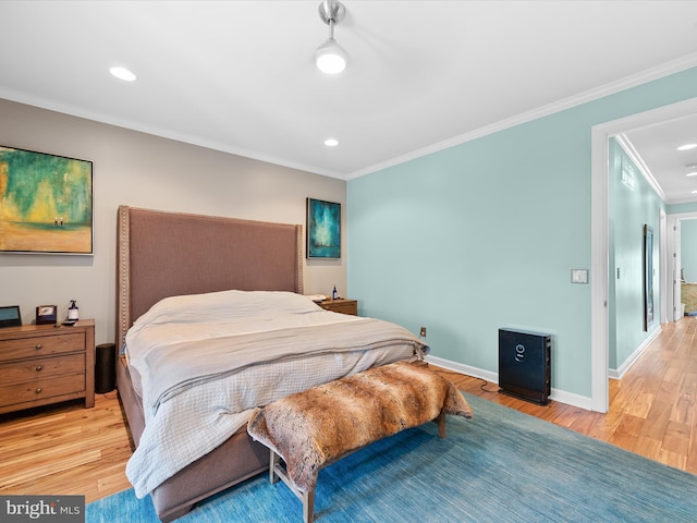 bedroom with crown molding and light hardwood / wood-style flooring