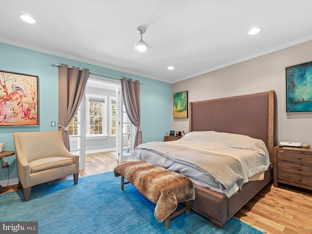 bedroom with crown molding and hardwood / wood-style floors