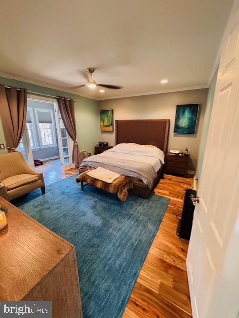 bedroom featuring access to exterior, wood-type flooring, ceiling fan, and ornamental molding