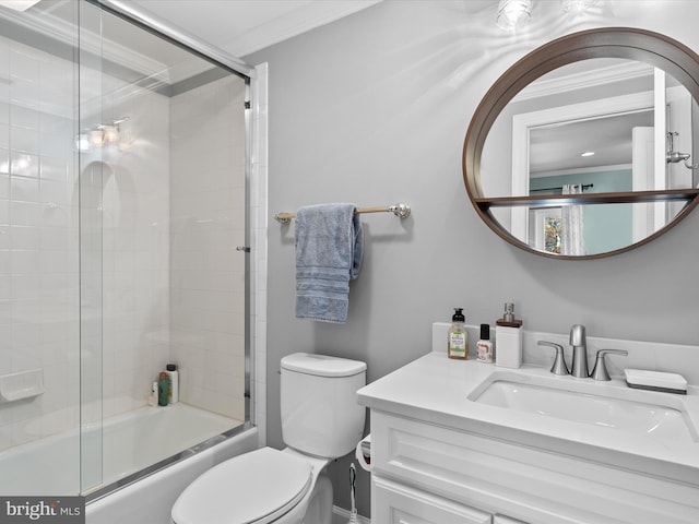 full bathroom featuring combined bath / shower with glass door, vanity, toilet, and crown molding