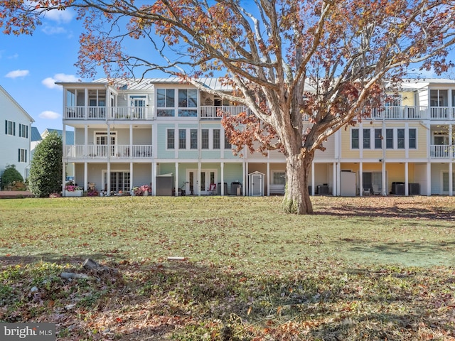 view of front of home with central AC and a front yard