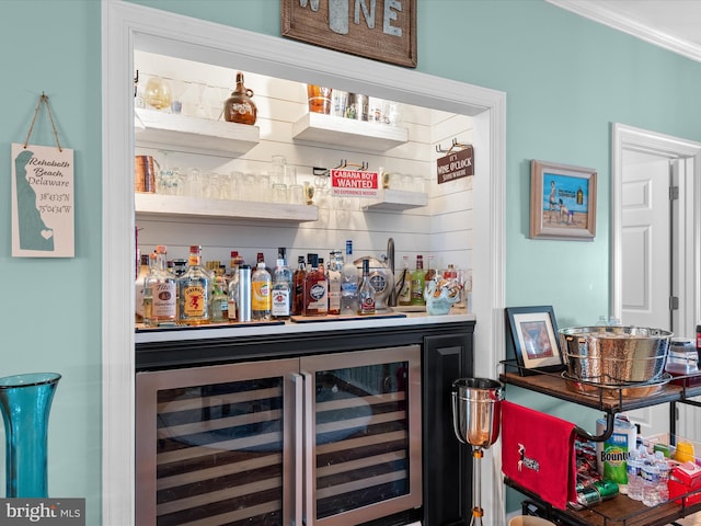 bar featuring wine cooler and ornamental molding