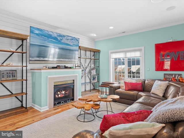 living room featuring ornamental molding and hardwood / wood-style flooring