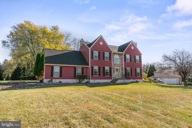 view of front of home featuring a front yard and a garage