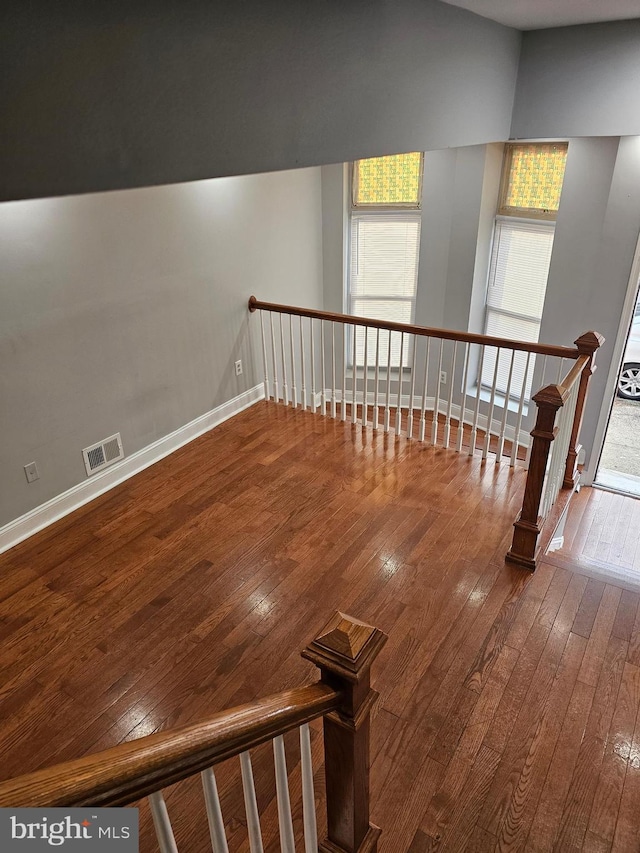 stairs featuring hardwood / wood-style flooring