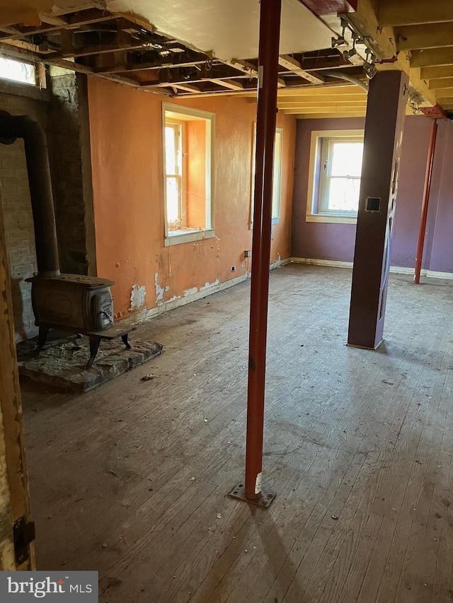 interior space featuring hardwood / wood-style floors and a wood stove