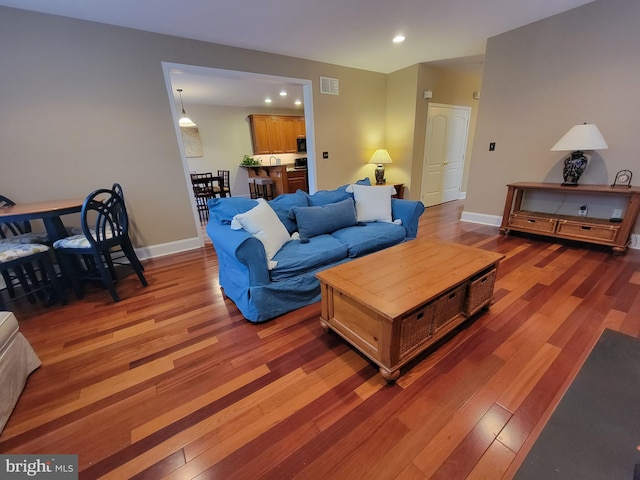 living room with dark hardwood / wood-style floors