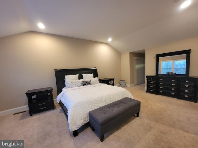 carpeted bedroom with lofted ceiling