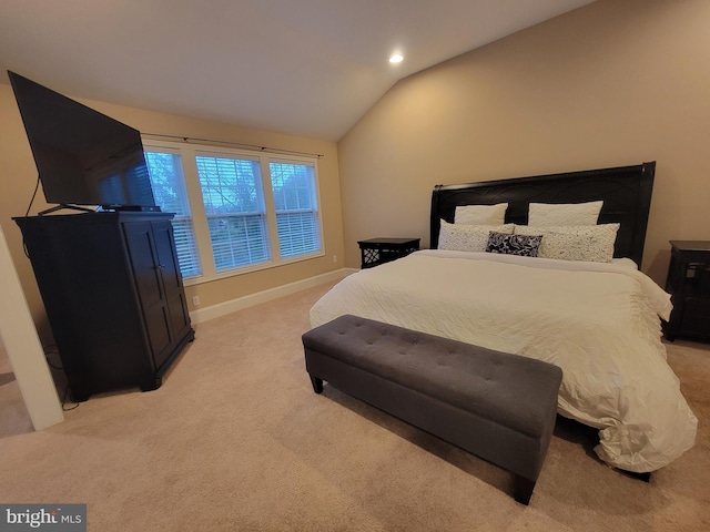 carpeted bedroom featuring lofted ceiling