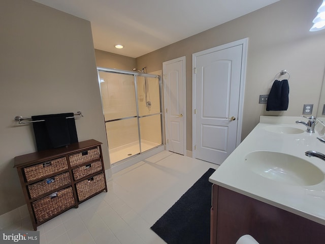 bathroom with vanity, tile patterned floors, and a shower with door