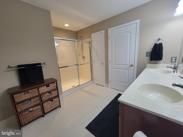 bathroom featuring tile patterned flooring, vanity, and a shower with door