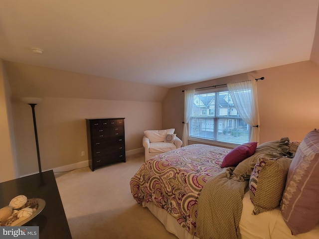 carpeted bedroom featuring lofted ceiling