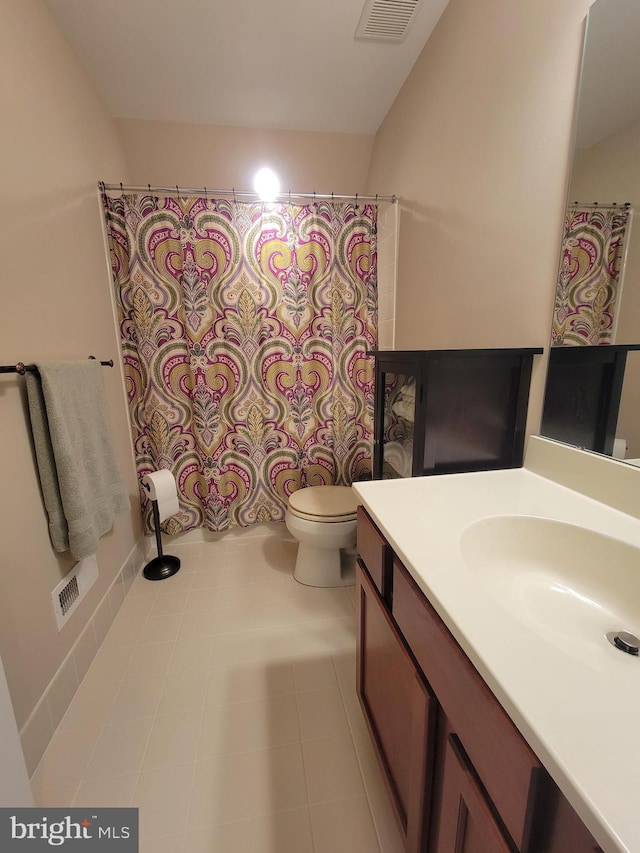 bathroom with tile patterned floors, vanity, and toilet