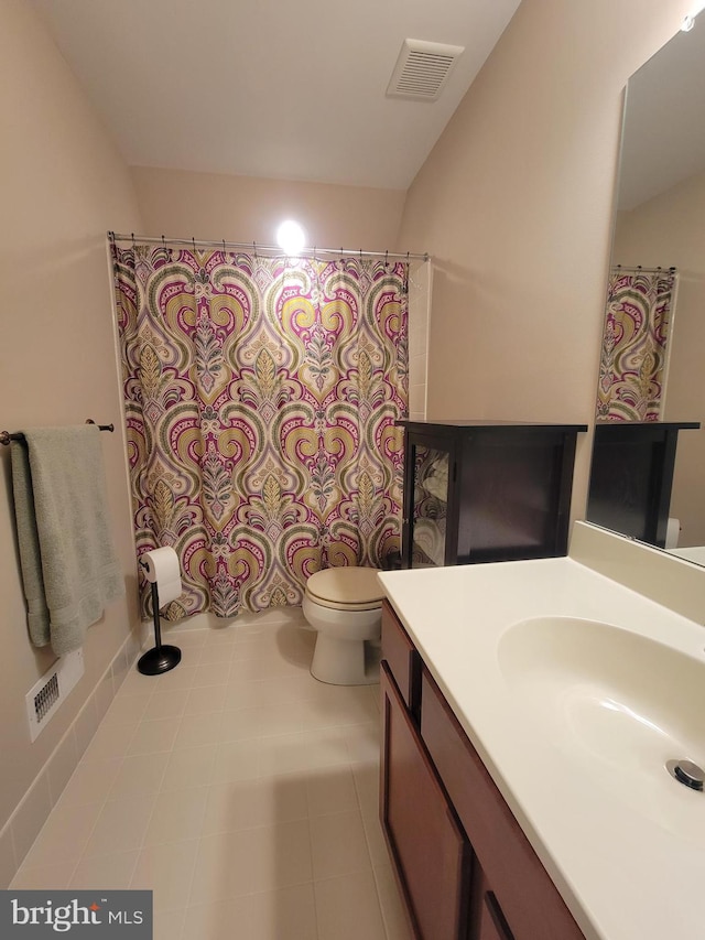 bathroom featuring tile patterned flooring, vanity, and toilet