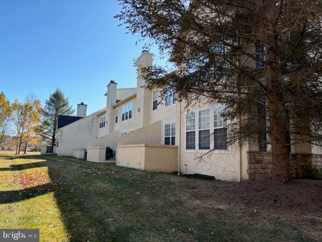 view of home's exterior with a yard