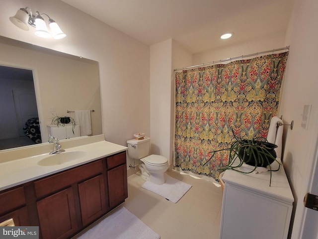 bathroom featuring vanity, toilet, and walk in shower