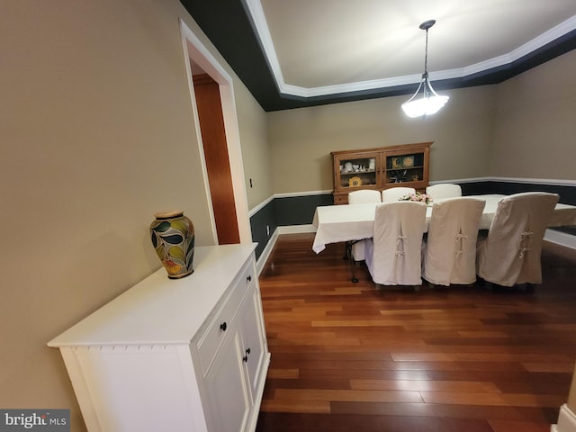 dining space featuring dark hardwood / wood-style flooring and crown molding