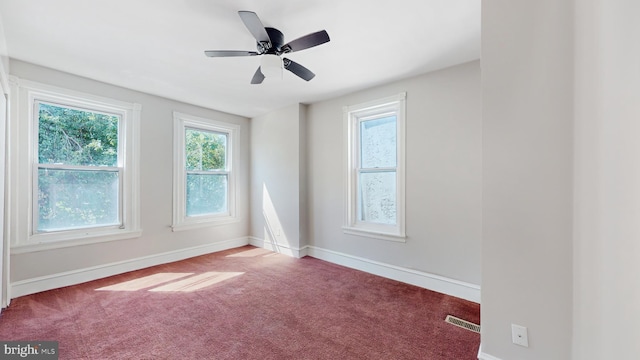 carpeted spare room with ceiling fan