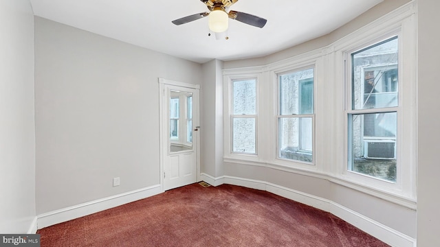 carpeted empty room featuring cooling unit and ceiling fan