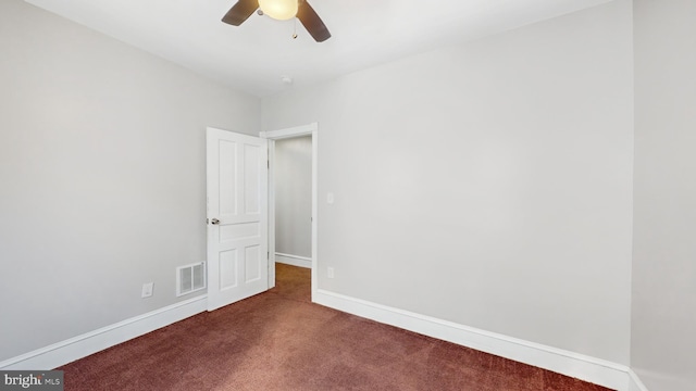 unfurnished room featuring ceiling fan and dark colored carpet