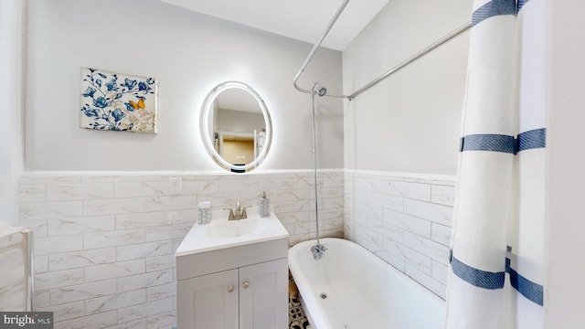 bathroom featuring vanity, tile walls, and shower / bath combo with shower curtain