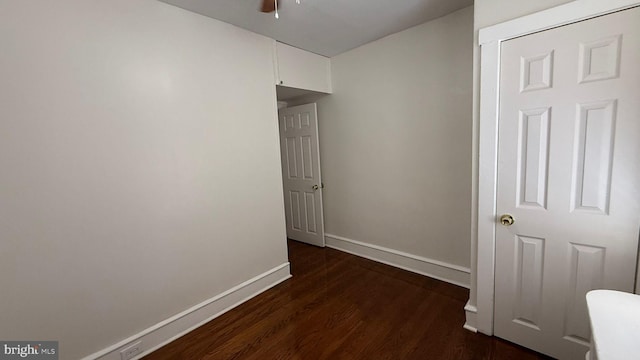 hallway with dark hardwood / wood-style floors