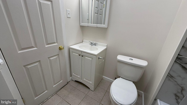 bathroom with vanity, tile patterned floors, and toilet