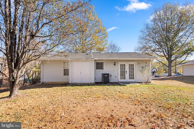 back of property featuring central AC unit, a yard, and french doors