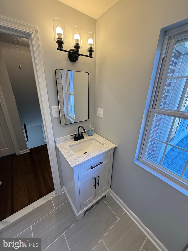 bathroom with hardwood / wood-style floors and vanity