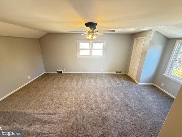 carpeted spare room with ceiling fan and lofted ceiling