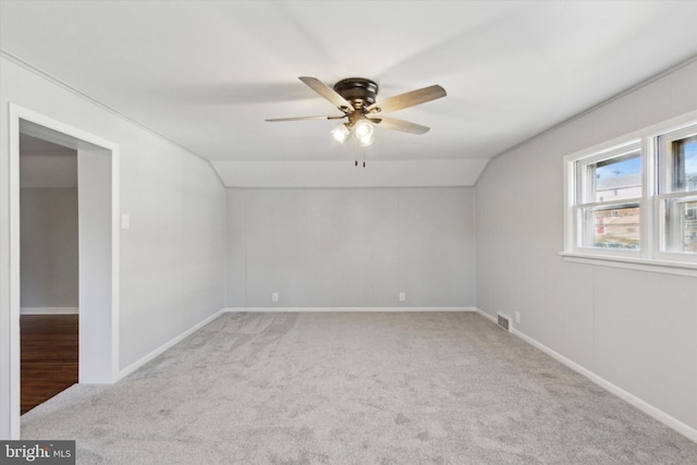 interior space with light carpet, vaulted ceiling, and ceiling fan