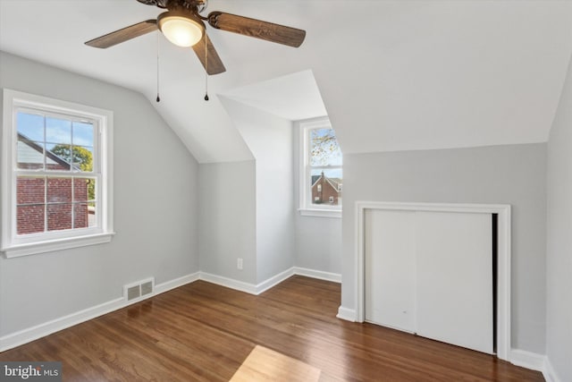 additional living space featuring vaulted ceiling, ceiling fan, and dark hardwood / wood-style floors