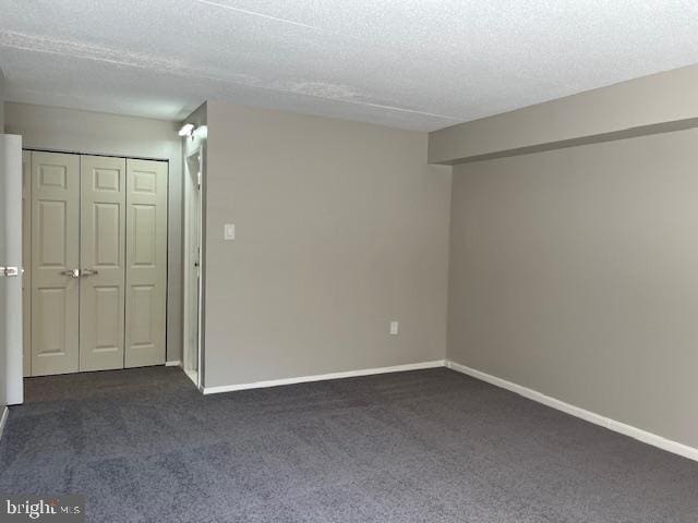 carpeted spare room featuring a textured ceiling