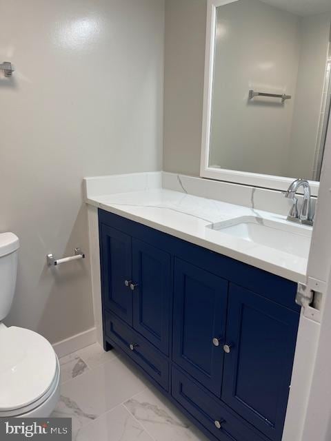 bathroom featuring toilet and vanity