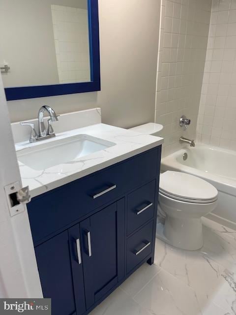 full bathroom featuring tiled shower / bath, toilet, and vanity