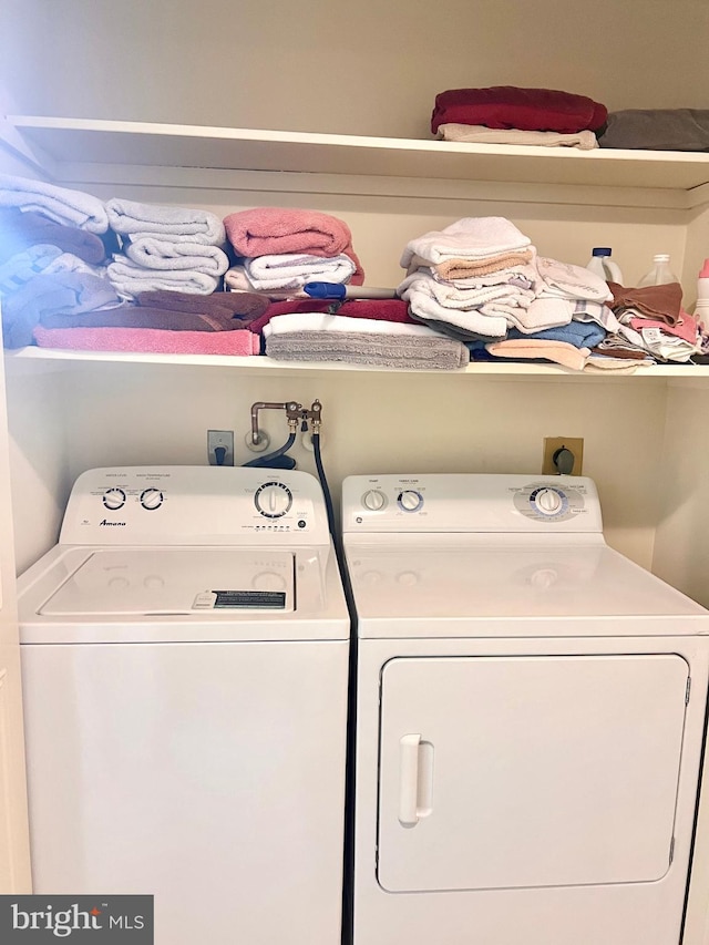 clothes washing area featuring washing machine and clothes dryer