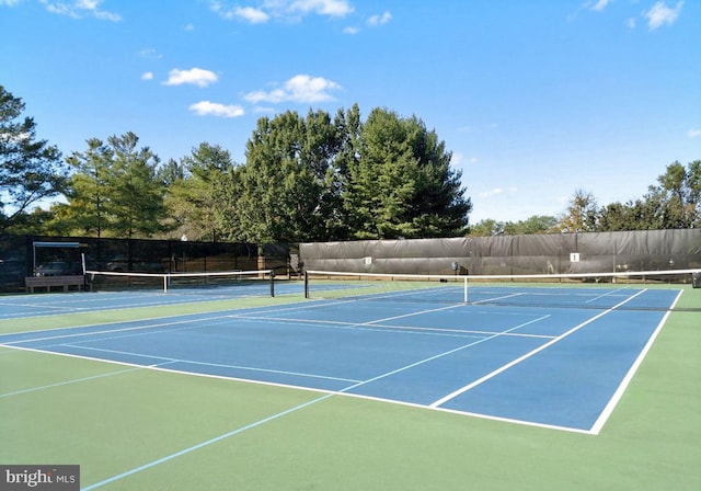 view of tennis court featuring basketball court