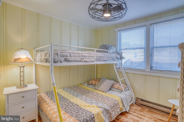 bedroom featuring light hardwood / wood-style floors and a baseboard radiator