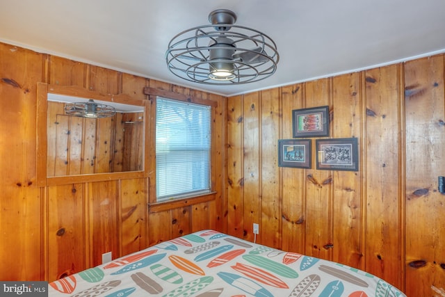 bedroom featuring wooden walls