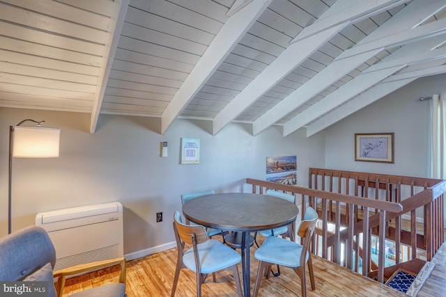 dining space featuring light hardwood / wood-style floors, vaulted ceiling with beams, wood ceiling, and heating unit