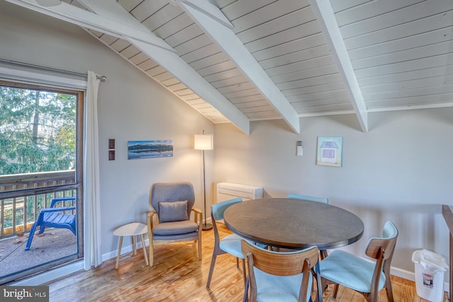 dining space featuring light wood-type flooring, vaulted ceiling with beams, and wooden ceiling