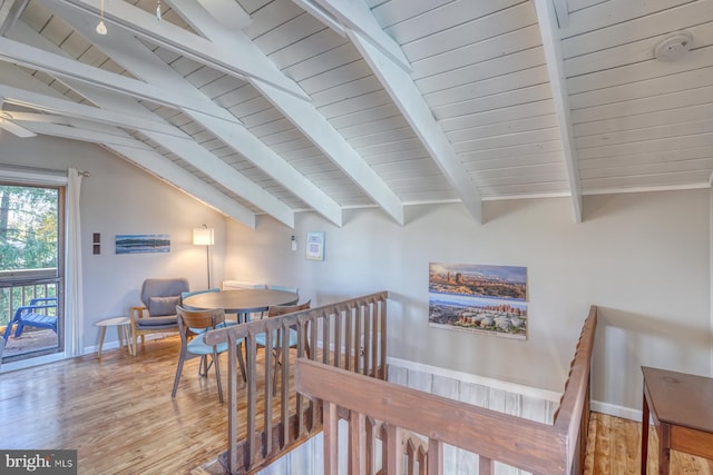 dining area featuring lofted ceiling with beams and hardwood / wood-style flooring