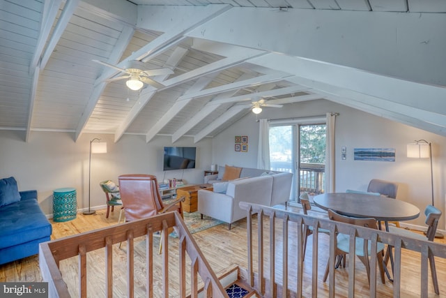 interior space with lofted ceiling with beams, hardwood / wood-style floors, and ceiling fan