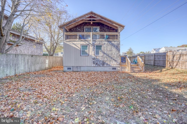 rear view of property with a balcony