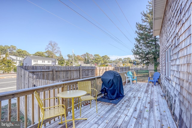 wooden terrace featuring a grill