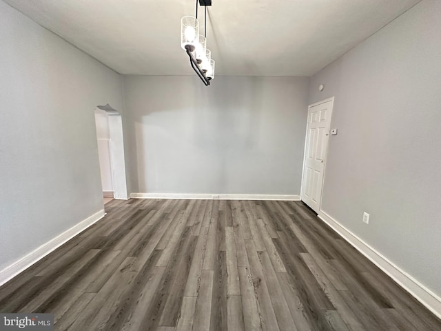 unfurnished dining area with dark wood-type flooring