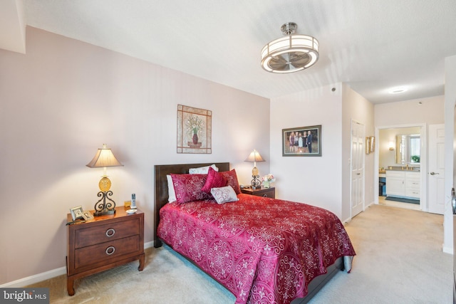 carpeted bedroom with ensuite bath