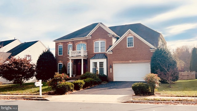 view of front of home with a garage and a balcony