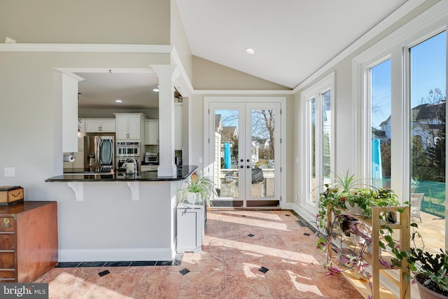 kitchen featuring a wealth of natural light, white cabinetry, kitchen peninsula, and french doors